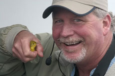 Seabird trip leader Roger Wolfe with Yellow Warbler